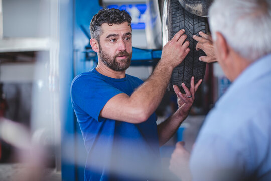 Mechanic in workshop with customer