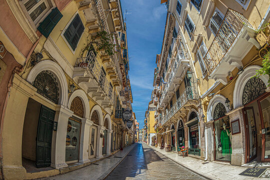 CORFU-KERKYRA, CORFU ISLAND, GREECE - JULY 29, 2022: Small street and typical houses located on the picturesque historic center of the city.