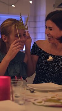 Happy Mother And Daughter In Party Outfits With Golden Crowns Taking Selfie, Vertical Video