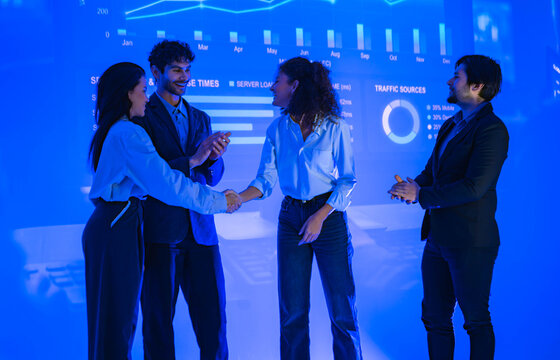 Business professionals shaking hands after a successful technology meeting