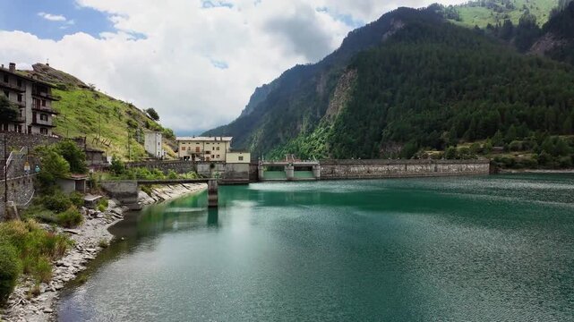 Pontechianale Lake in Piedmont: man-made dam. August holidays in the mountains