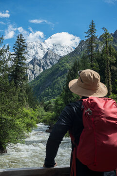 natural snow-capped mountain landscape and the silhouette of a backpacker