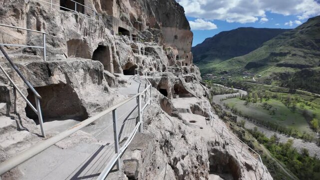 Stone stairs leading up to Vardzia cave monastery carved into Erusheti Mountain cliffs in Georgia, a historical 12th-century medieval landmark