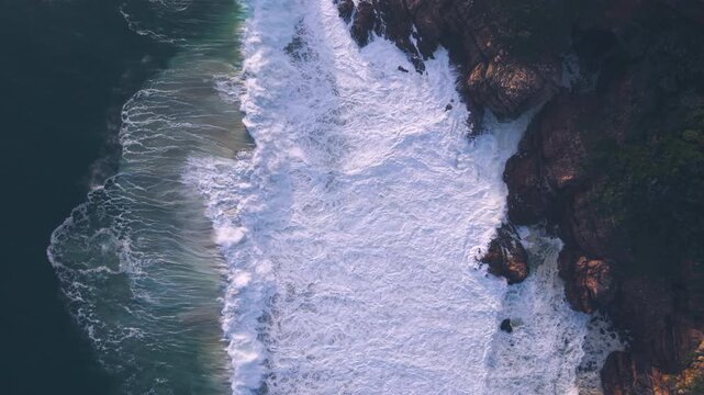 Aerial overhead waves breaking on the coastline