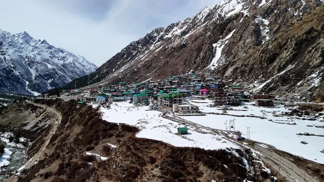 Scenic Aerial View of Chitkul Village Covered in Snow with Himalayan Mountains, Snowy Landscape, Traditional Mountain Homes, Frozen Winter Scenery, Cloudy Sky and Beautiful Kinnaur Valley Nature View