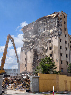 Building destruction in a city with heavy machinery working during daytime