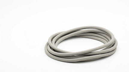 Naklejka premium Coiled light grey silicone cord isolated on white. Flexible rubber cable loop