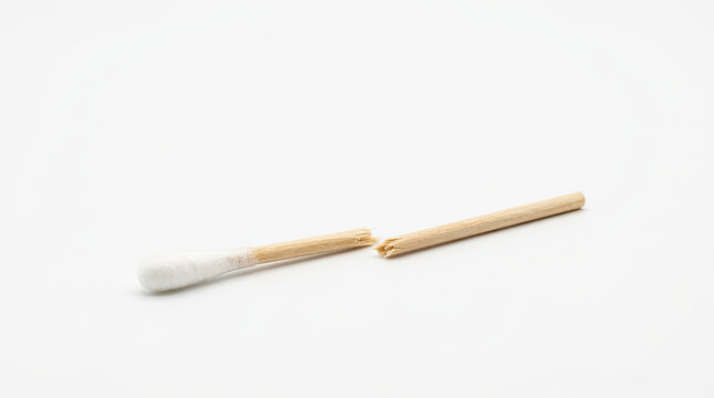 Broken cotton swab isolated on white background. Snapped wooden Q-tip in two pieces. Damaged personal hygiene tool
