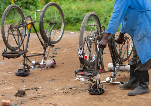 Rwandan man repairing bicycles in the street, Northwest Province, Rehengeri, Rwanda