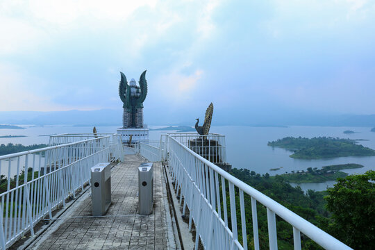 Sumedang, West Java, Indonesia - May 23, 2026: Paved Walkway With Metal Railings Leads To Turnstiles And A Tall Twin Monument
