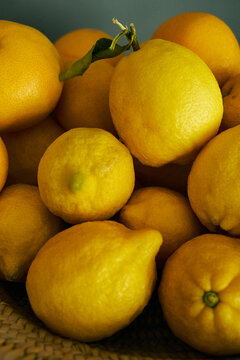 Close up heap of vibrant yellow lemons and grapefruits
