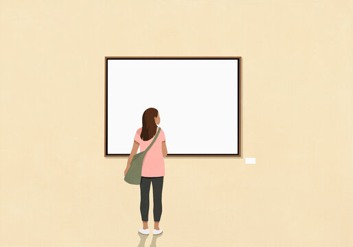Woman looking at art and label hanging on yellow museum wall