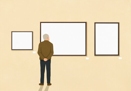 Senior man looking at paintings hanging on museum wall