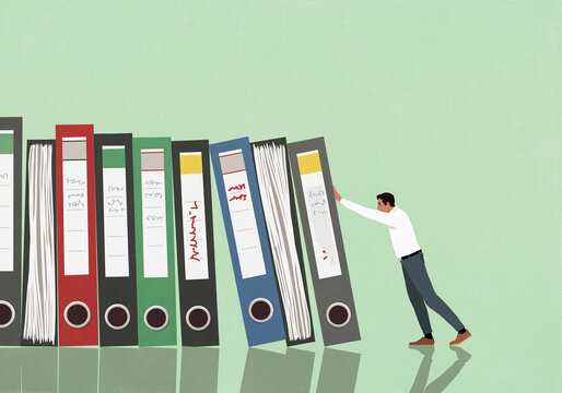 Domino effect - businessman pushing document files against green background