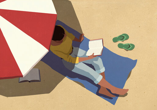 View from above young woman reading book and relaxing under striped umbrella on sunny summer beach