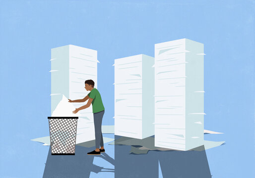 Man sorting organizing stacks of paperwork