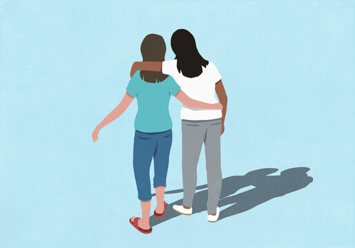 Young women walking with arms around each other