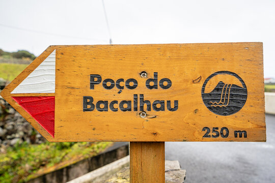 Pedestrian trail sign leading to the Po&ccedil;o do Bacalhau waterfall, Ilha das Flores, Azores, Portugal.