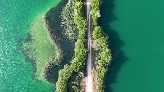 Aerial cenital view flying over a lake road in Xinzo de Limia