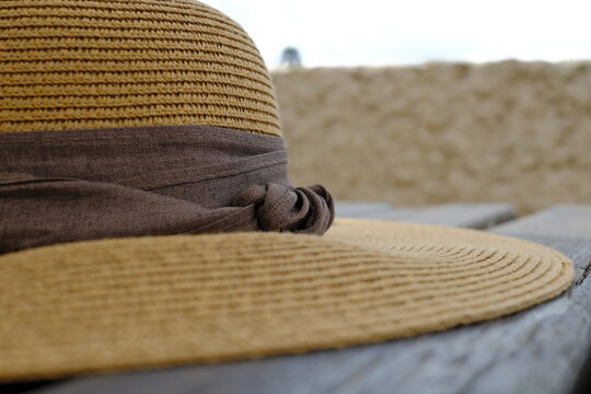 Close up of summer straw hat with brown ribbon