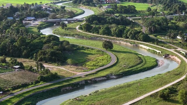 Drone footage shows a meandering river and plantation fields near Kubang Semang.