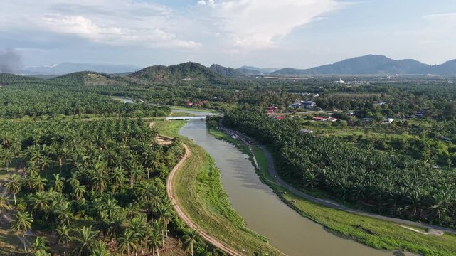 Drone footage showing palm plantation, river, roads and village near Kubang Semang in Malaysia