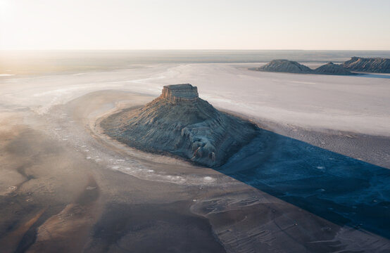 Aerial view of Karynzharyk depression with its distinctive rocky outcrops and salt flats in Karakiya District, Mangystau Region, Kazakhstan.