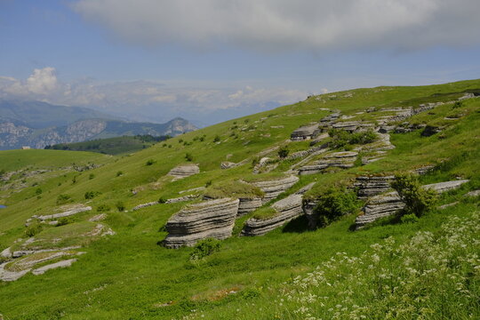 Mountain landscape in Malga Lessinia with limestone rocks and green hills