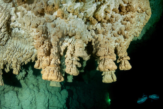 Beautiful underwater cenote cave with ancient limestone formations in Mexico