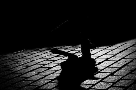 Silouette feet on coblestone in street