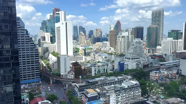 Time Lapse Bangkok City Skyline with Elevated Skytrain Under Blue Sky and Clouds 