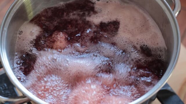 Octopus tentacles cooking in boiling water with steam rising