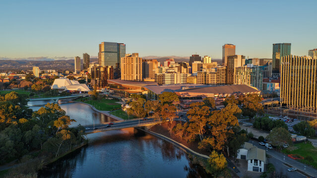 Adelaide City, South Australia &ndash; 4K aerial drone footage of CBD skyline, Towers, River Torrens, Convention Centre, Elder Park, city bridges and golden sunset cityscape.