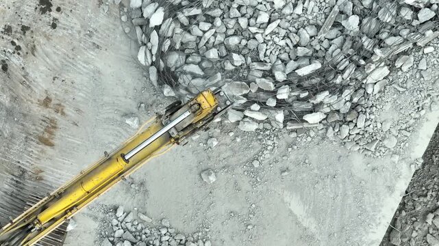 Drone footage of hydraulic demolition machinery breaking reinforced concrete into rubble, showcasing structural renewal, excavation work, infrastructure maintenance, efficient construction technology.
