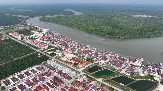 Aerial drone view of Kuala Gula riverside town and mangrove