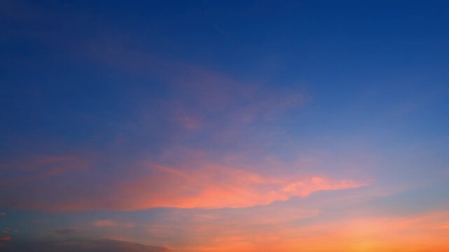 A sunset sky timelapse video featuring soft cirrostratus and altostratus clouds glowing in orange, pink, and deep blue tones, suggesting dream travel, sky poetry, digital calm and twilight beauty. 4k.