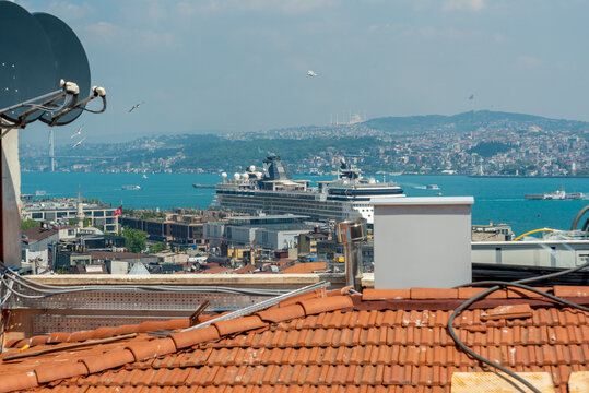 Turkey, Istanbul, June 26, 2026. View of Galataport with cruise ship, waterfront buildings and boats on the water.