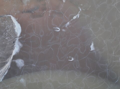 Aerial view of intricate ice patterns on the frozen surface of the river near Selfoss, Sveitarfelagid Arborg, Iceland.