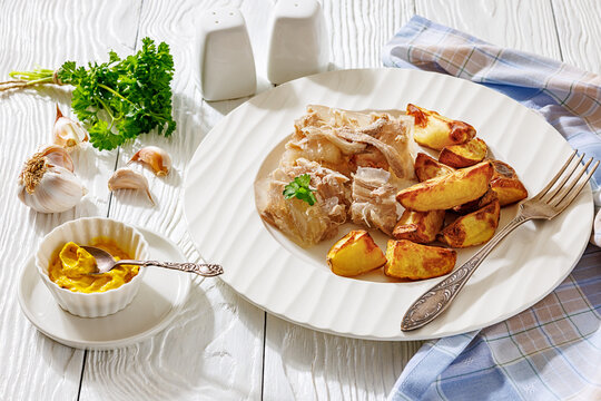 Traditional pork jelly dish with baked potatoes
