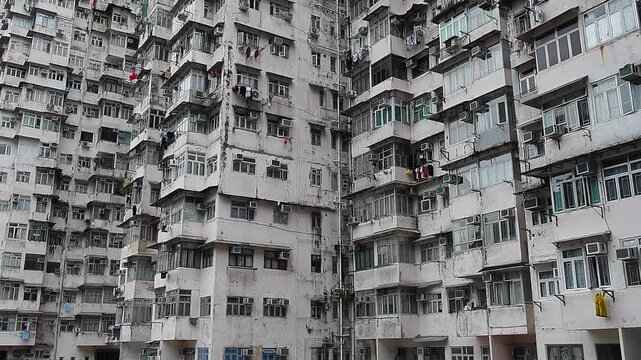 The Monster Building is a complex of five interconnected residential blocks in Quarry Bay, Hong Kong. Known for its dense urban, facade is filled with air conditioners, drying laundry.