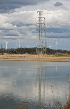  electricity pylons reflecting in the water of a marsh in Groot Rietveld, Kalo, Antwerp, Belgium 