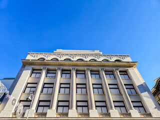 Classic neoclassical building facade against blue sky © Studio-M