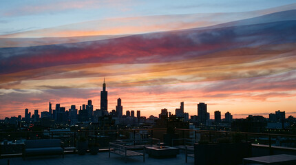 Fototapeta premium City rooftop terrace at sunset with subtle layered translucent bands of different seasonal sunset color palettes overlapping gently in the same sky