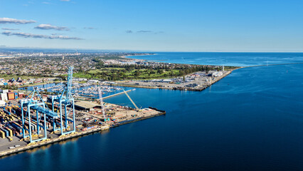 Outer Harbor, South Australia – 4K aerial drone view of Flinders Adelaide Container Terminal, container port, cargo terminal, logistics hub, industrial waterfront, RSAYS Marina and North Haven. © Thomas