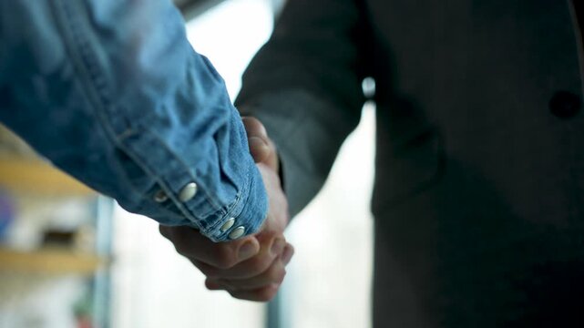 handshake between colleagues in a business office setting