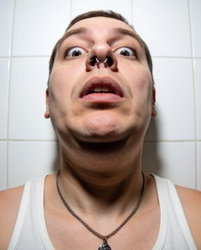 close-up of shocked person looking into phone