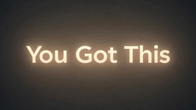 Motivational phrase 'You Got This' glowing in light orange text on a dark, subtle background, conveying encouragement and confidence.