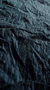 Crumpled Texture with Linear Motion. Video showing dynamic movement over a dark rough texture with crumpled details.	