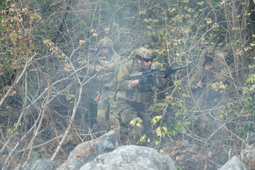Fototapeta premium Soldiers group together to perform their duties in wartime soldiers in camouflage uniforms carrying weapons conduct patrols through dangerous mountainous forest areas.