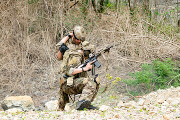 Fototapeta premium Special forces units, armed with war weapons are joining forces in unity surprise attack preparing mission to assault the enemy military. 